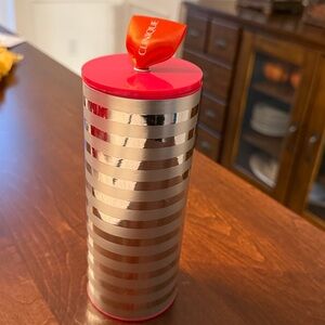 Clinique brand Silver and pink Striped Tumbler for storage or gifting.